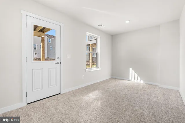 a view of a hallway with wooden floor and entryway