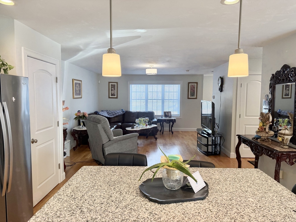 60 A Danforth Street, Unit A Taunton, MA 02780 - Photo 3 of 10 a living room with furniture kitchen view and a wooden floor