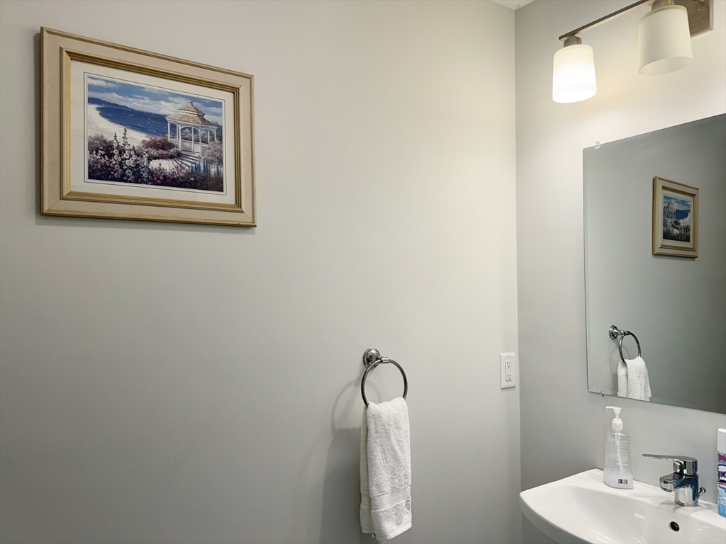 60 A Danforth Street, Unit A Taunton, MA 02780 - Photo 4 of 10 a bathroom with a painting on the wall and a sink