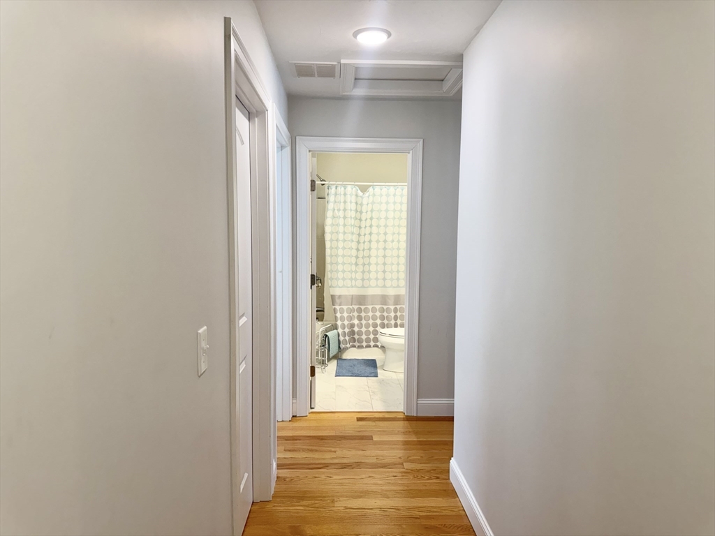 60 A Danforth Street, Unit A Taunton, MA 02780 - Photo 10 of 10 a view of a hallway with wooden floor and a dining room