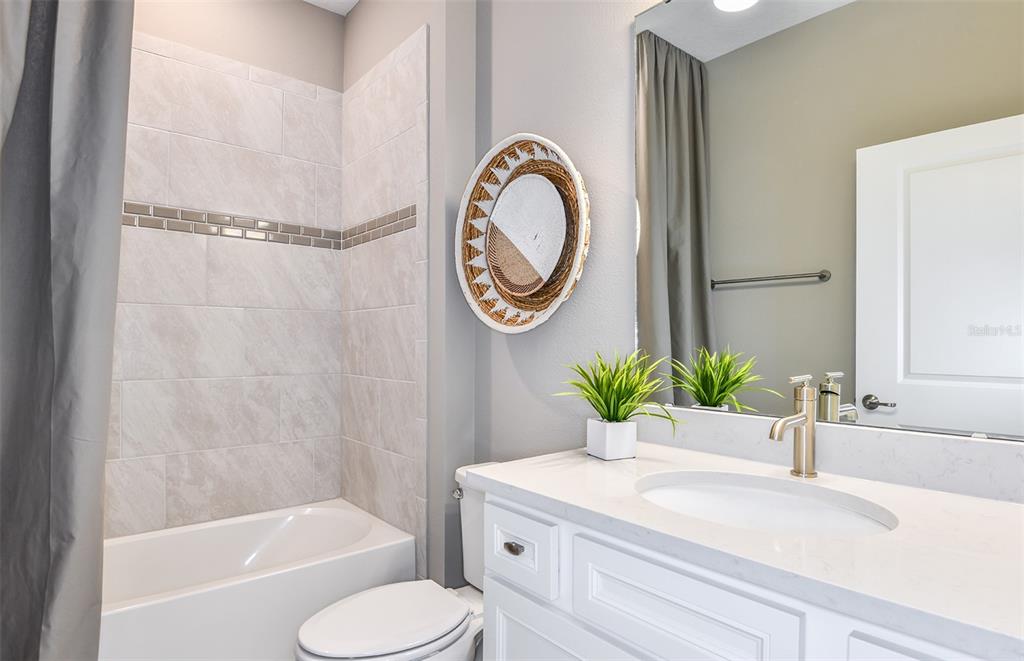 1320 Orange Vly Road Minneola, FL 34715 - Photo 22 of 23 a bathroom with a granite countertop sink and a bathtub