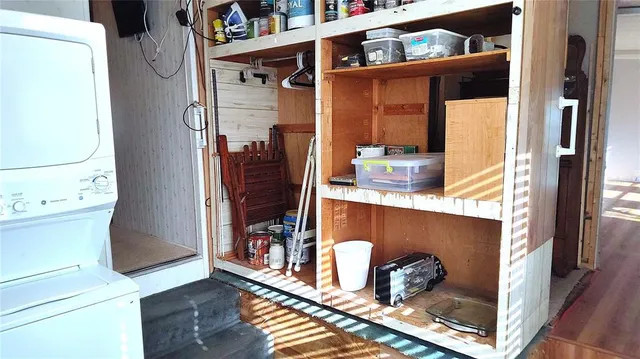 a view of walk in closet with wooden floor