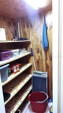 a room with water heater and wooden racks