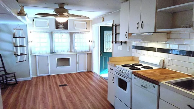 a kitchen with stainless steel appliances granite countertop a stove and a refrigerator