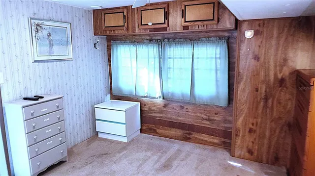 a room with a dresser and a window