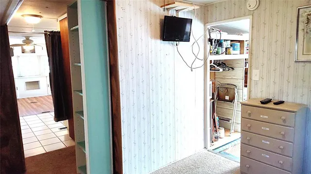 a bedroom with a bed and a flat tv screen