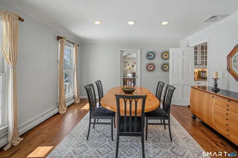 a view of a dining room with furniture window and wooden floor