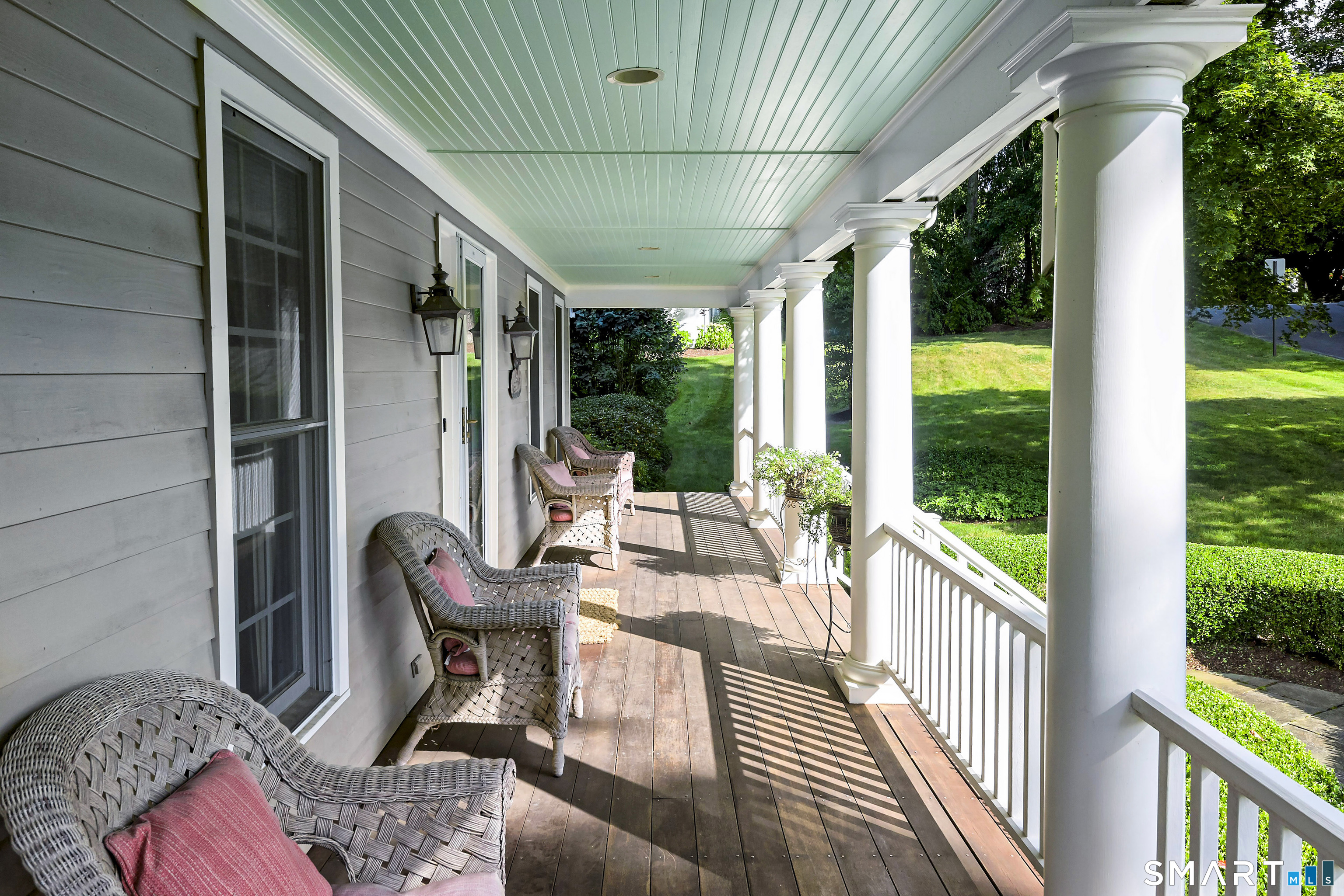 6 Sycamore Lane Ridgefield, CT 06877 - Photo 13 of 39 a view of a porch with furniture and a yard