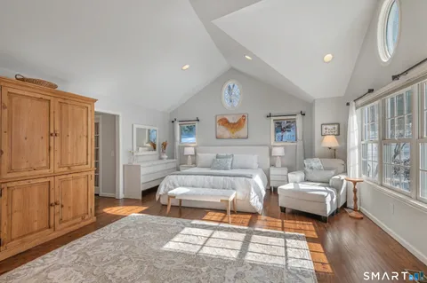 a living room with furniture wooden floor and a rug