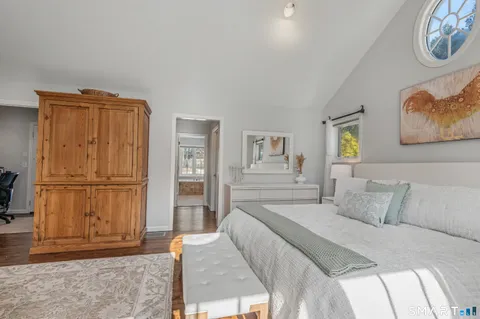 a bedroom with a bed and a refrigerator