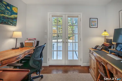 a view of a workspace with furniture and a window