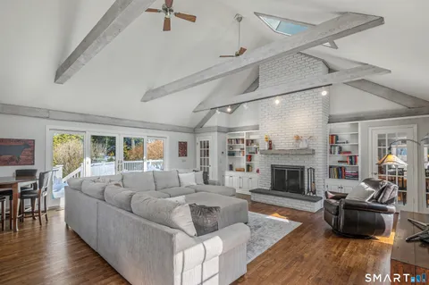 a living room with furniture and a wooden floor