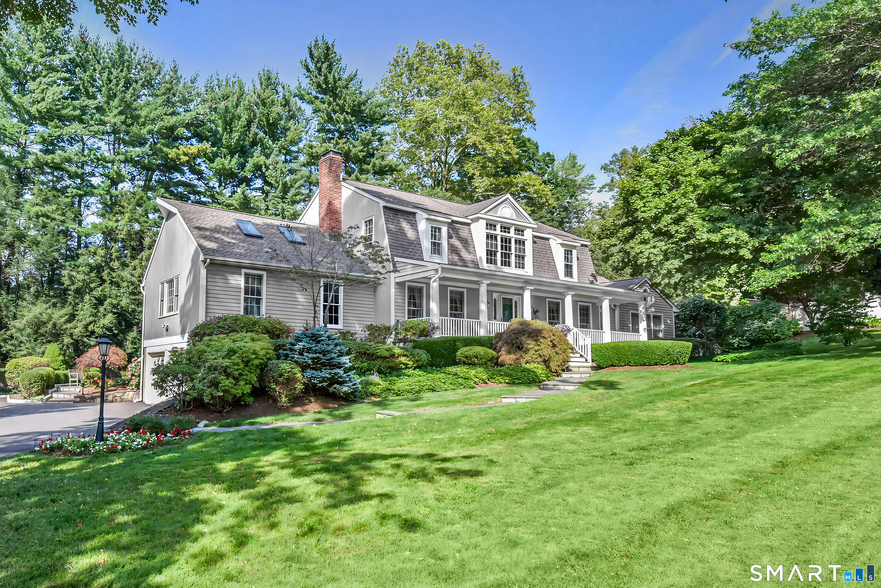 6 Sycamore Lane Ridgefield, CT 06877 - Photo 32 of 39 a front view of a house with a garden