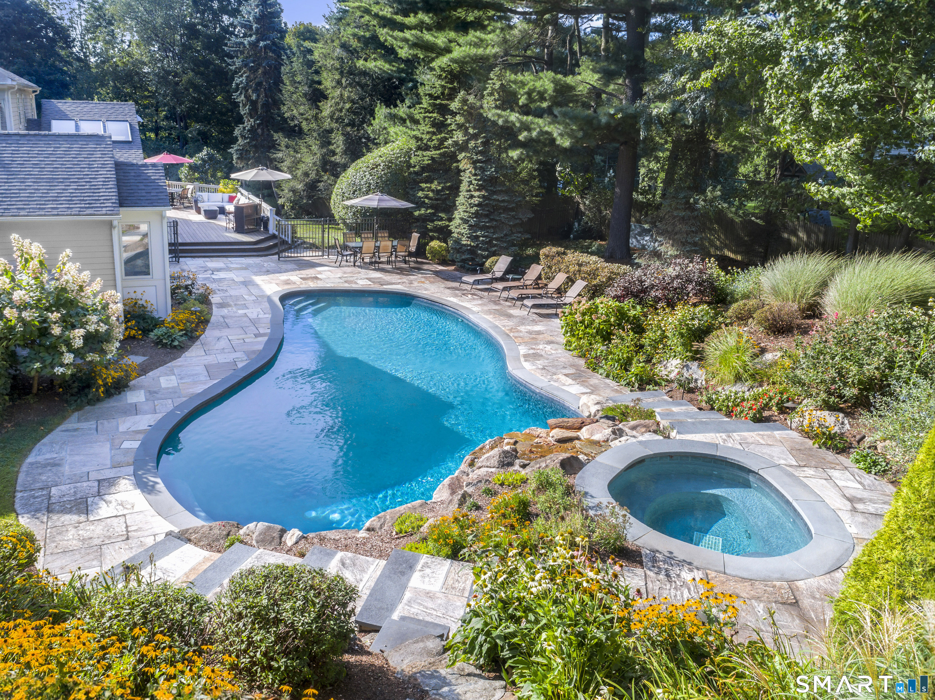 6 Sycamore Lane Ridgefield, CT 06877 - Photo 33 of 39 a view of a swimming pool with lawn chairs and plants