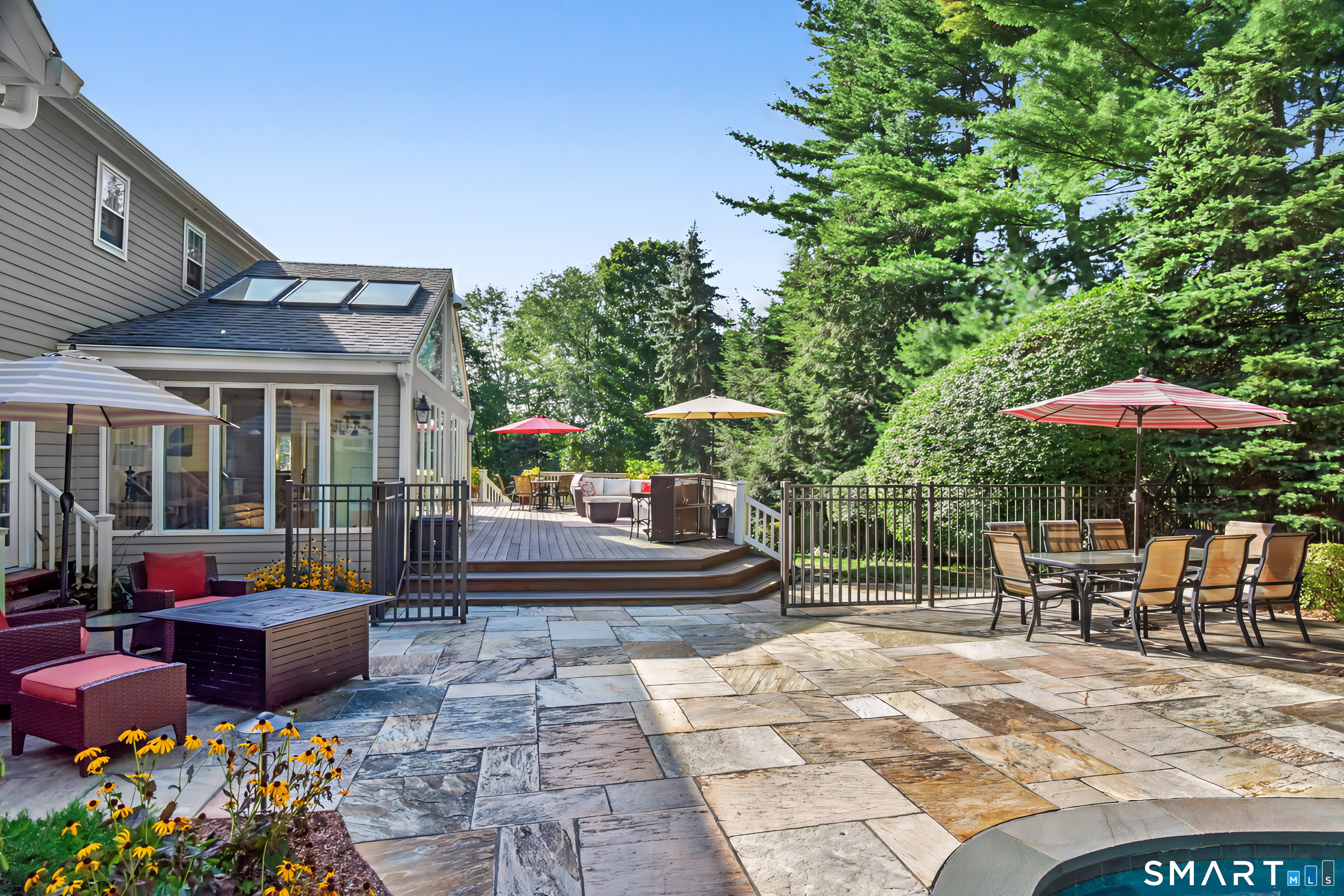 6 Sycamore Lane Ridgefield, CT 06877 - Photo 34 of 39 a view of a patio with table and chairs potted plants and a small yard