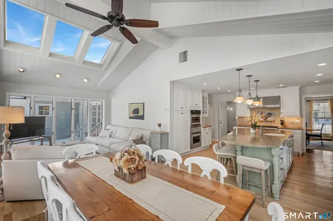 a room with stainless steel appliances kitchen island granite countertop furniture and a view of kitchen