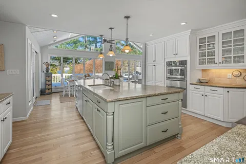a kitchen with counter top space sink and stove