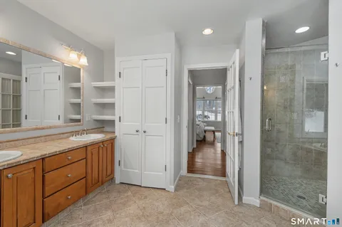 a bathroom with a granite countertop sink mirror and shower