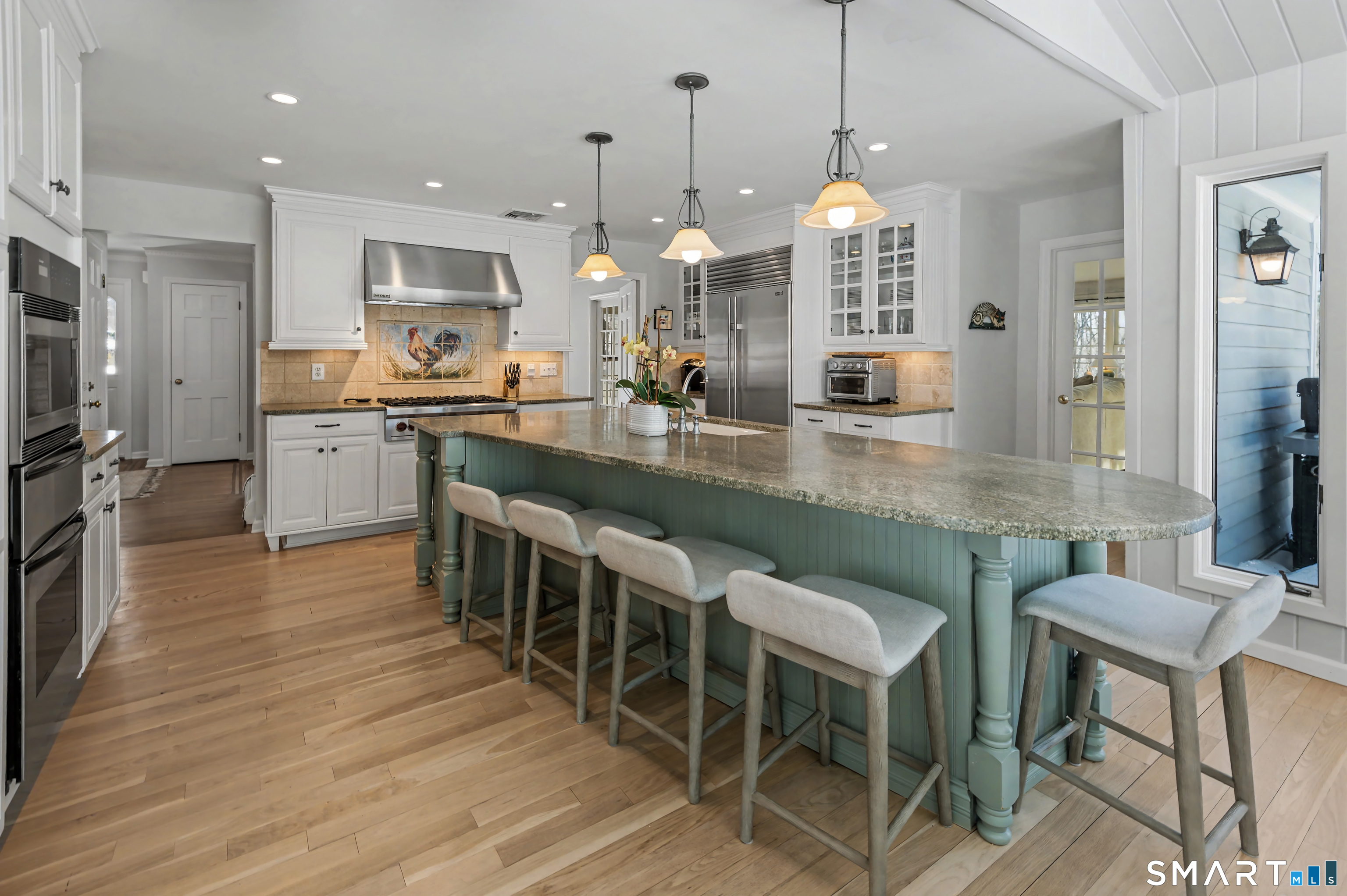 6 Sycamore Lane Ridgefield, CT 06877 - Photo 8 of 39 a kitchen with kitchen island granite countertop a table chairs sink and cabinets