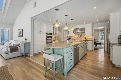 a large kitchen with a table and chairs