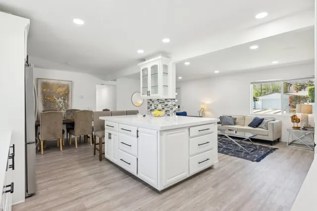 a spacious bedroom with a bed and a dresser