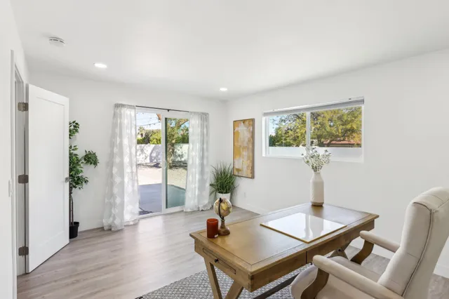 a living room with furniture and wooden floor