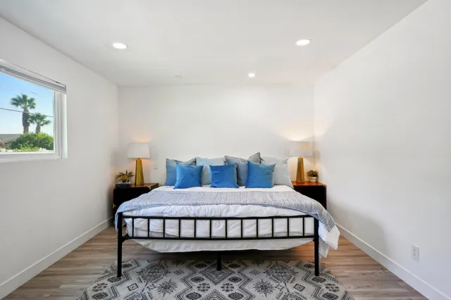 a bedroom with a bed and a window