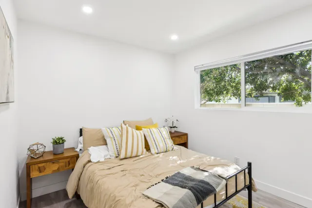 a bedroom with a bed and a window