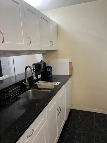 a kitchen with sink and cabinets