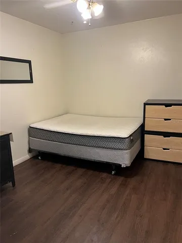 a room with a bed and a dresser