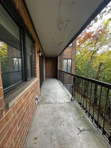 a view of porch with wooden floor and stairs