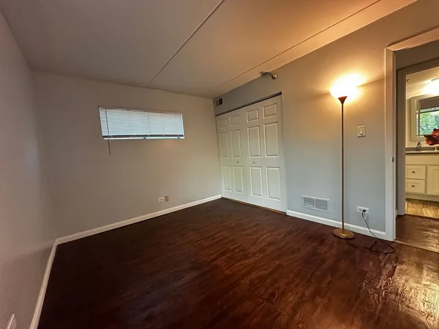 a bathroom with a granite countertop sink toilet and mirror
