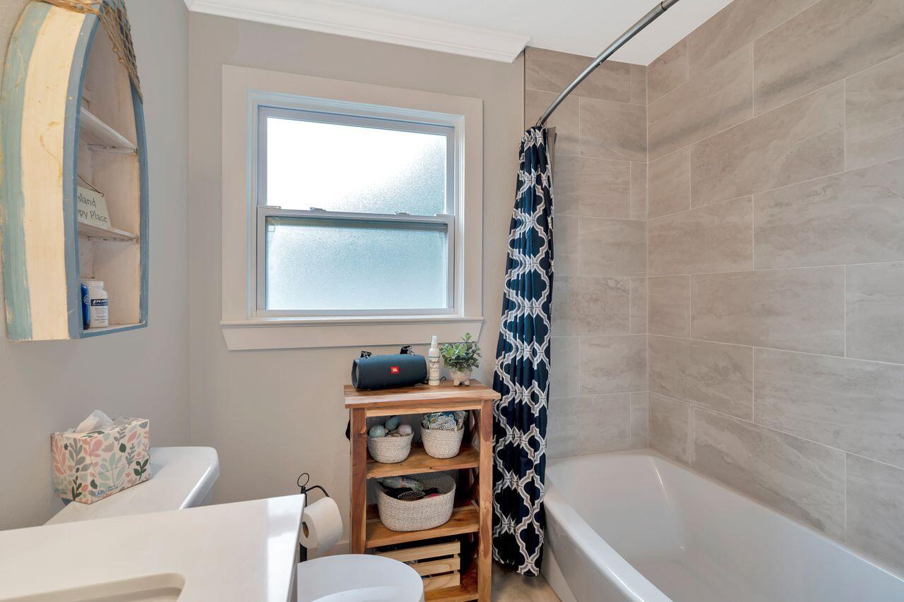 13382 Highway 20 Freeport, FL 32439 - Photo 23 of 31 a bathroom with a bathtub a window and a shower