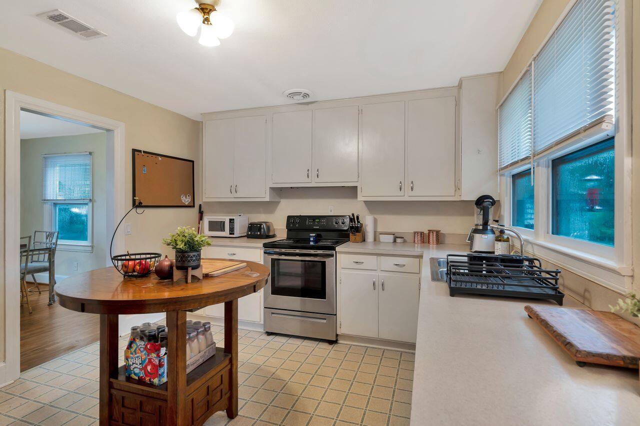 13382 Highway 20 Freeport, FL 32439 - Photo 8 of 31 a kitchen with stainless steel appliances a stove a sink and a microwave