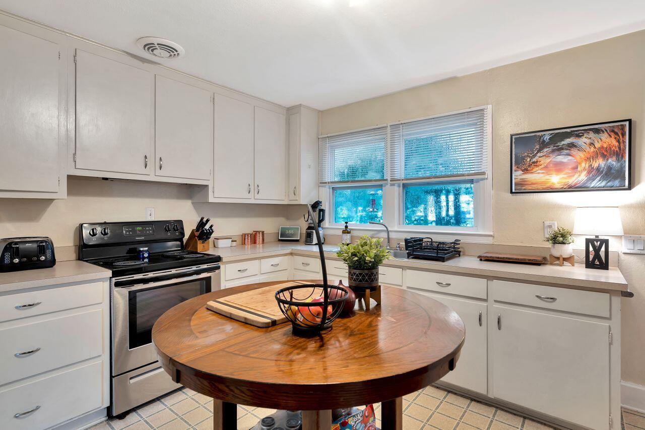 13382 Highway 20 Freeport, FL 32439 - Photo 9 of 31 a kitchen with sink a stove and chairs