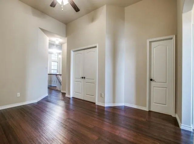 an empty room with wooden floor and closet
