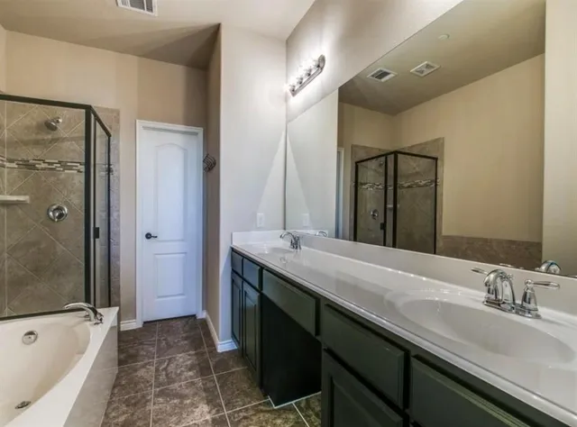 a bathroom with a granite countertop sink mirror and a bathtub