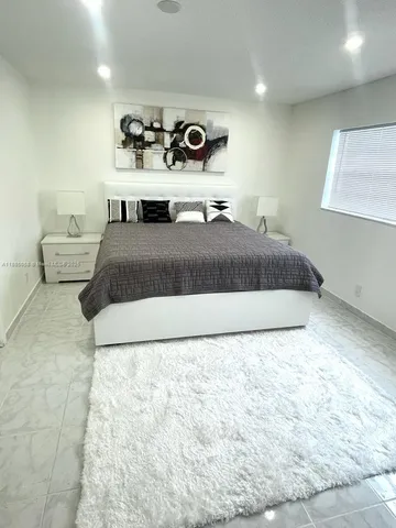 a bedroom with a bed and a lamp