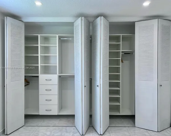 a view of walk in closet with empty racks