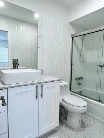 a bathroom with a sink toilet and shower