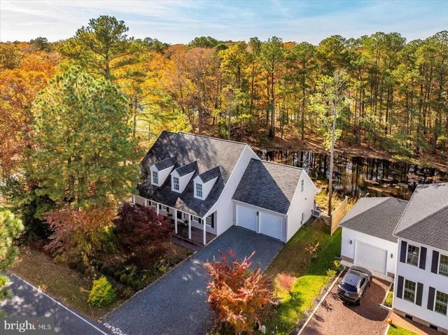 an aerial view of a house with a yard basket ball court and outdoor seating