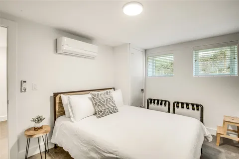 a bedroom with a bed and a lamp with window