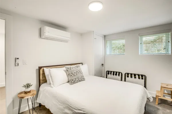 a bedroom with a bed and a lamp with window