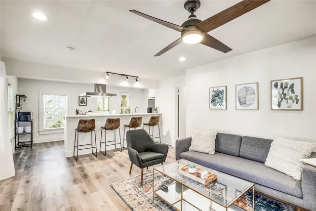 a living room with furniture and a wooden floor
