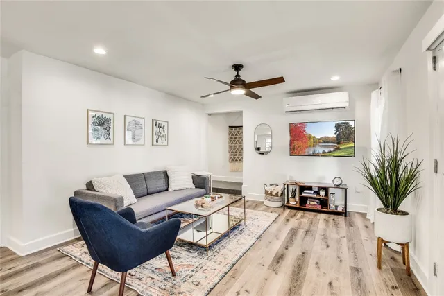a living room with furniture a window and a potted plant