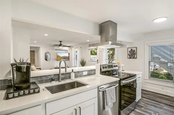 a kitchen with a stove and a sink