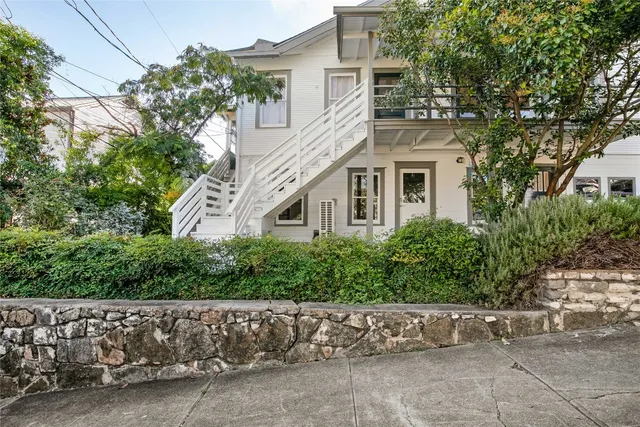 a front view of a house with a garden