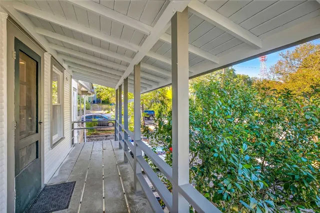 a view of balcony with couch and wooden floor