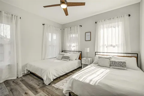 a bedroom with two beds and a window