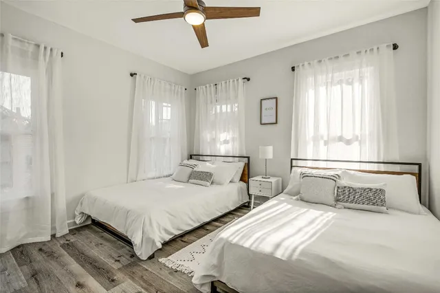 a bedroom with two beds and a window